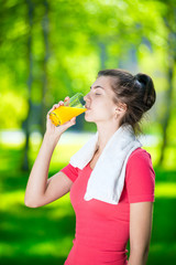 Fototapeta premium Woman drinking fresh orange juice
