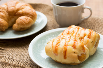 Bread with Sausage , cup of black coffee