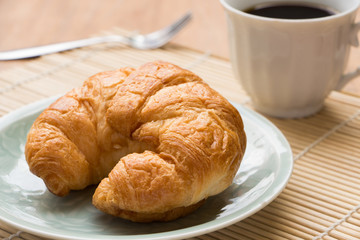breakfast with croissants, cup of black coffee