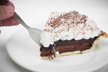 Chocolate tart with fork in white background