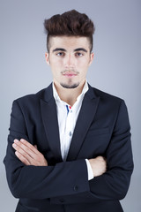 Portrait of a serious businessman standing with arms crossed