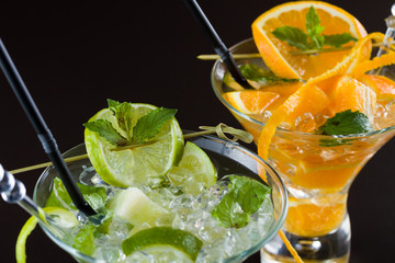 Orange and lime Mojito over black  background