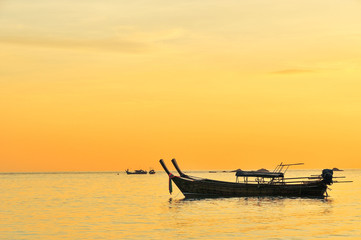 silhouette of boat in the sea during sunset
