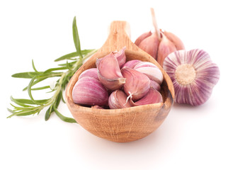 Garlic cloves in wooden bowl isolated on white background