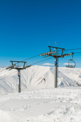 Fototapeta na wymiar Skilift on ski resort during winter on bright day