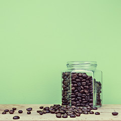 Coffee on green background on wooden surface