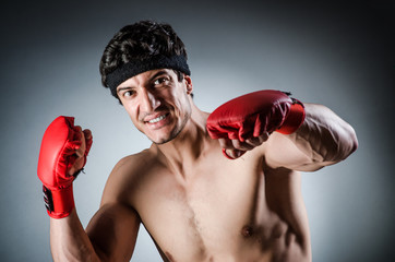 Muscular boxer wiith red gloves