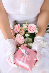 Obraz na płótnie Canvas Bride in gloves holding wedding bouquet, close-up