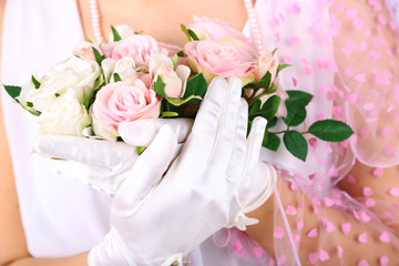 Fototapeta premium Beautiful bride in white gloves holding wedding bouquet,