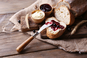 Fresh bread with homemade butter and blackcurrant jam