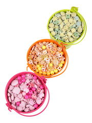 Beads in coloured metal buckets isolated on white