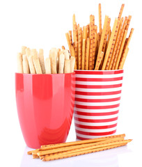 Sticks in red cups on white background isolated