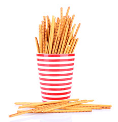 Sticks in red cups on white background isolated