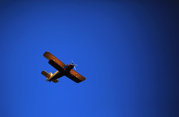 Retro-biplane aircraft, against the blue sky