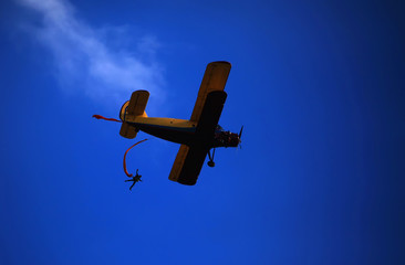 Parachutist jumps aircraft blue sky background