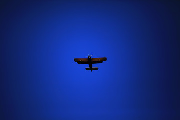 Retro-biplane aircraft, against the blue sky