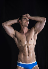 Fototapeta premium Attractive young man standing with muscular ripped body
