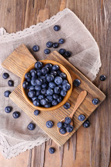 Wooden bowl of blueberries