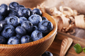 Wooden bowl of blueberries