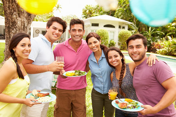 Group Of Friends Having Party In Backyard At Home