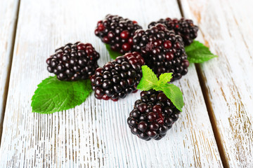 Blackberries on grey wooden background