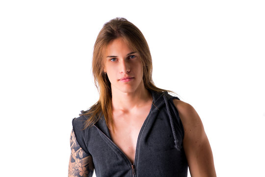 Beautiful young long haired man in jacket posing