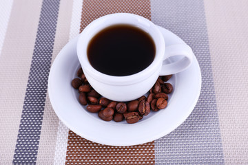 Cup of fresh hot coffee on table cloth