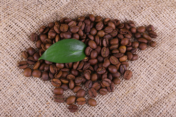 Coffee beans on sacking background closeup