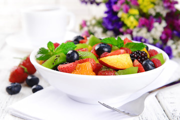 Delicious fruits salad in plate on table close-up