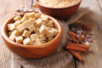 Brown sugar cubes, reed and crystal sugar in bowl with spices