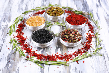 Spices with herbs on wooden background