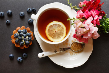 cup of tea with cake and flowers