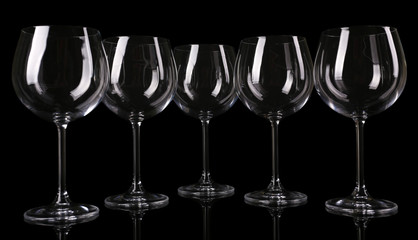Empty wine glasses isolated on black