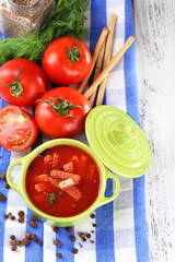 Tasty tomato soup with croutons on table close-up