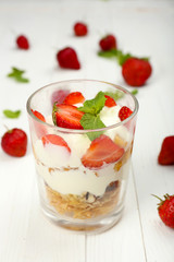 Natural yogurt with fresh berries on wooden table
