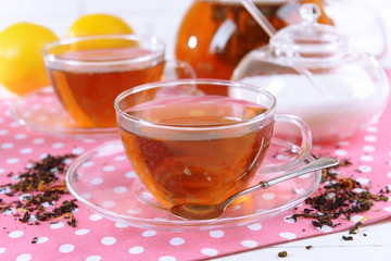 Teapot and cups of tea on table close-up