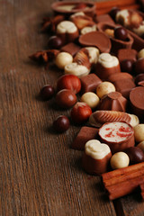 Different kinds of chocolates on wooden table close-up