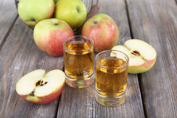 Still life with tasty apple cider in barrel and fresh apples