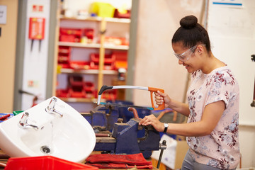 College Students Studying Plumbing Working At Bench
