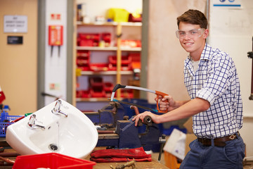 College Students Studying Plumbing Working At Bench