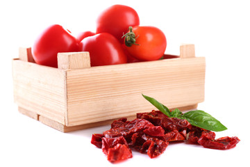 Sun dried tomatoes, fresh tomatoes in wooden box,  basil