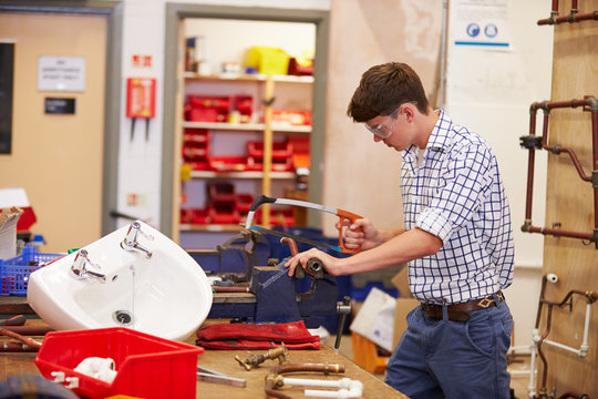 College Students Studying Plumbing Working At Bench