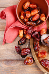 Tasty dates fruits on wooden background