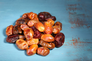 Tasty dates fruits on blue wooden table