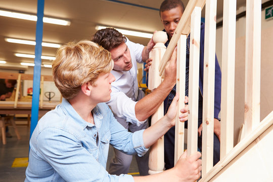 Students In Carpentry Class Working On Staircase