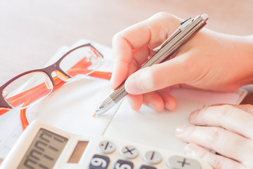 Businesswoman working with calculator and pen