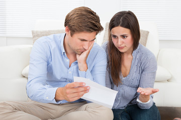 Couple Discussing Over Document At Home