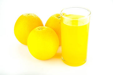 glass of fresh orange juice and oranges on white background