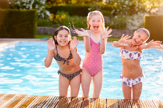 Group Of Girls Playing In Outdoor Swimming Pool