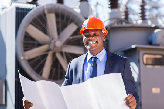young african electrical manager holding blueprint